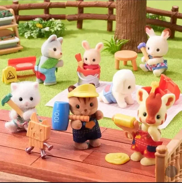 Calico Critters Toy figurines of animals in a picnic setting with a wooden table and grass background.