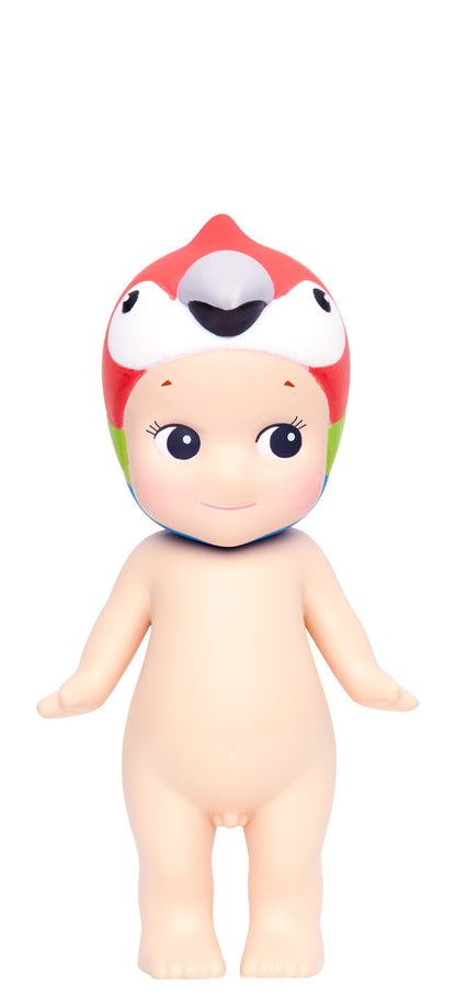 Toy figure with a colorful macaw hat on a white background