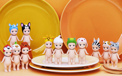 Set of baby figurines with various hairstyles and accessories on a yellow background